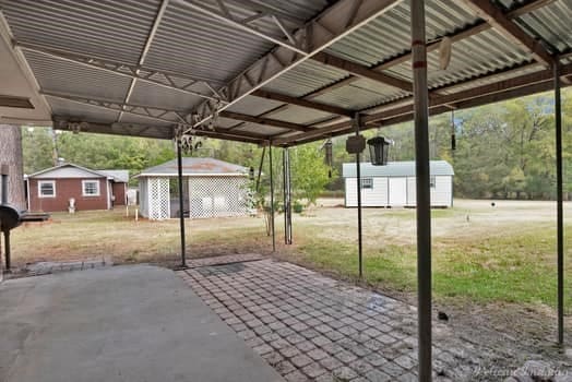 view of patio / terrace featuring a storage shed and an outdoor structure