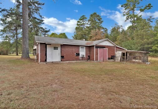 view of outbuilding featuring a yard