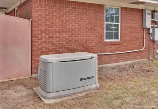 exterior details featuring a power unit and brick siding