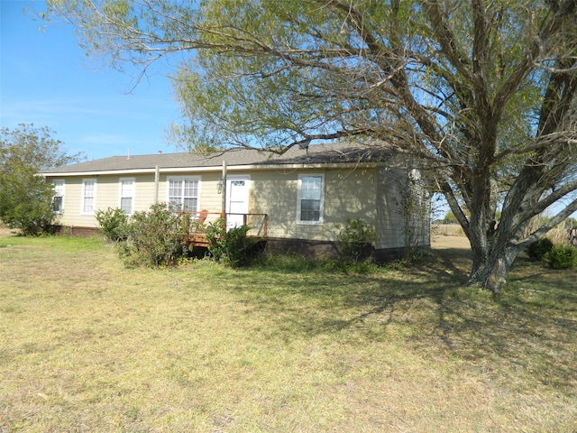 back of house featuring a deck and a yard