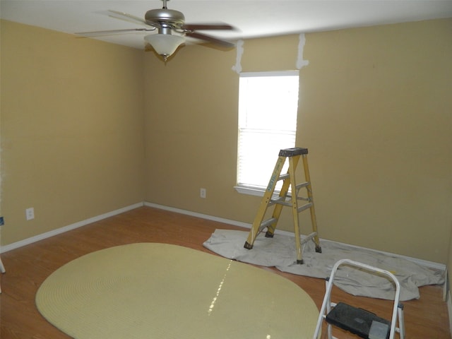 empty room with hardwood / wood-style floors and ceiling fan