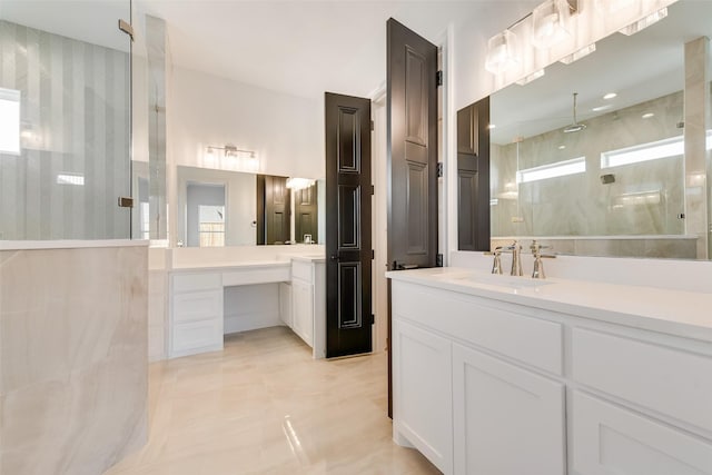 bathroom with tiled shower and vanity