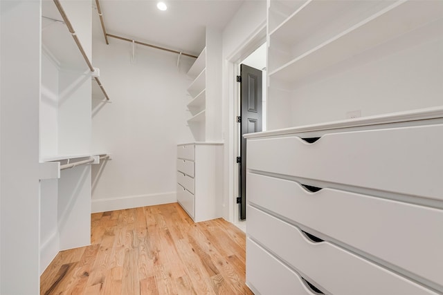 spacious closet featuring light hardwood / wood-style flooring