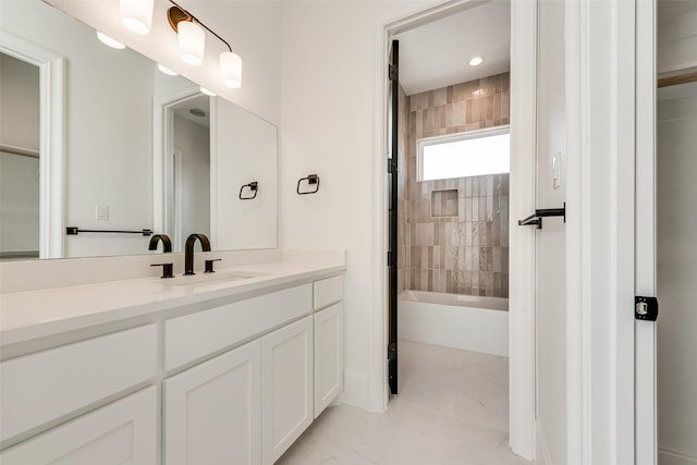 bathroom with vanity and tiled shower / bath