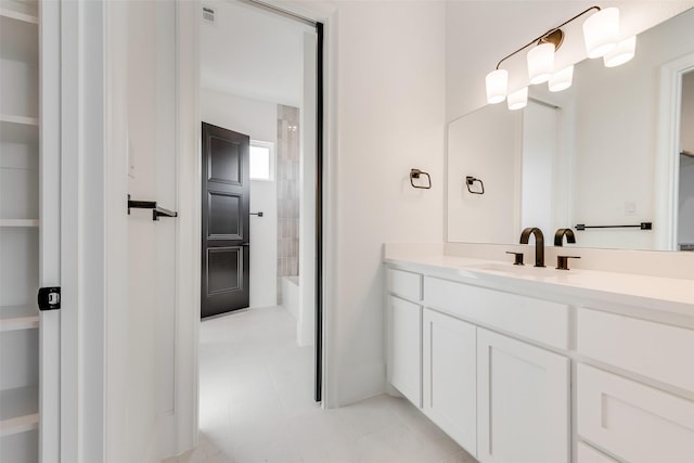 bathroom featuring vanity, tile patterned flooring, and washtub / shower combination