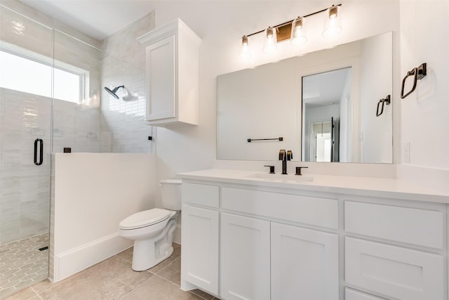 bathroom with toilet, vanity, tile patterned flooring, and a shower with shower door