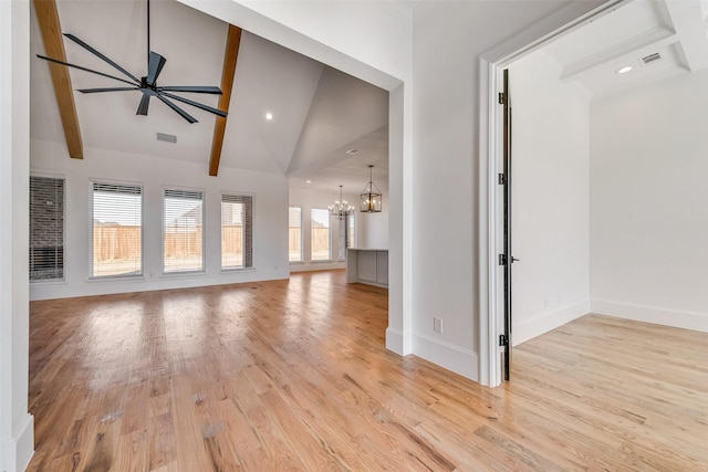 unfurnished living room with ceiling fan with notable chandelier, high vaulted ceiling, light wood-type flooring, and beam ceiling