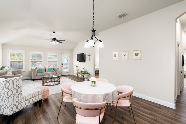 dining room with lofted ceiling, ceiling fan with notable chandelier, and dark hardwood / wood-style flooring