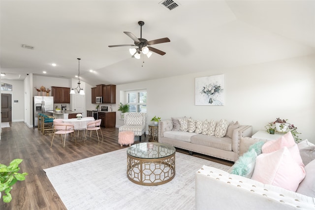 living room with ceiling fan, dark wood-type flooring, and vaulted ceiling