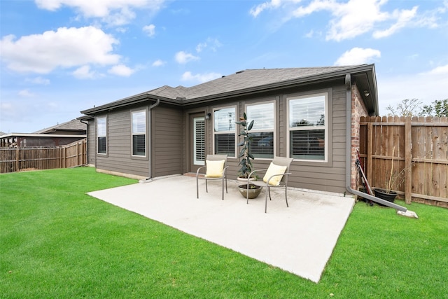 back of property featuring a patio area and a yard