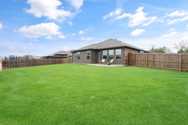 back of house featuring a patio and a lawn