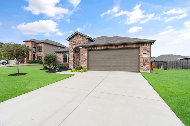 view of front of home featuring a front yard and a garage