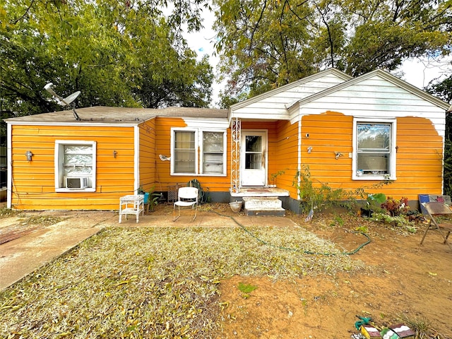 view of front of home with cooling unit and a patio area