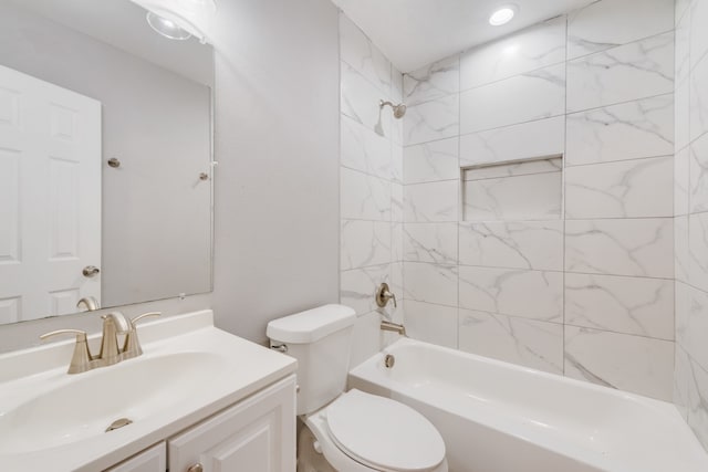 full bathroom with vanity, tiled shower / bath combo, and toilet