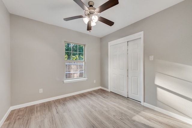 unfurnished bedroom with a closet, light wood-type flooring, and ceiling fan