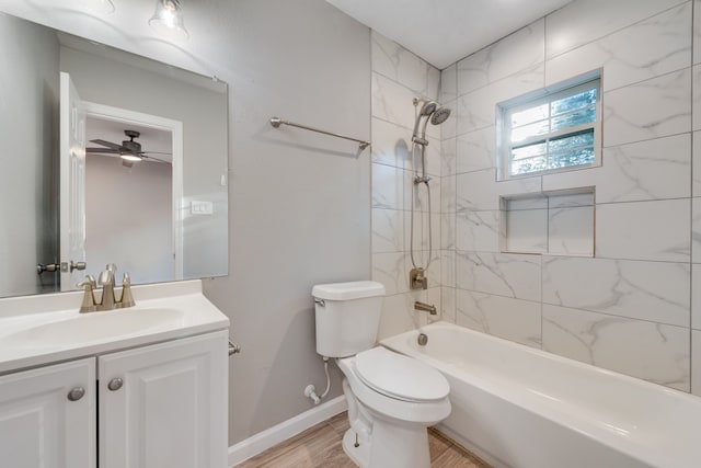 full bathroom with wood-type flooring, toilet, ceiling fan, vanity, and tiled shower / bath combo