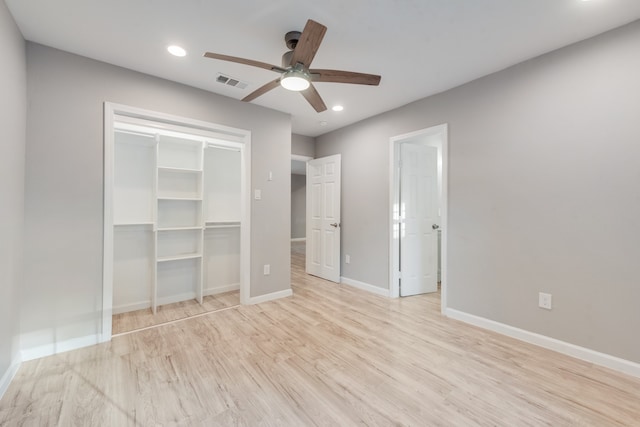 unfurnished bedroom with a closet, light hardwood / wood-style floors, and ceiling fan