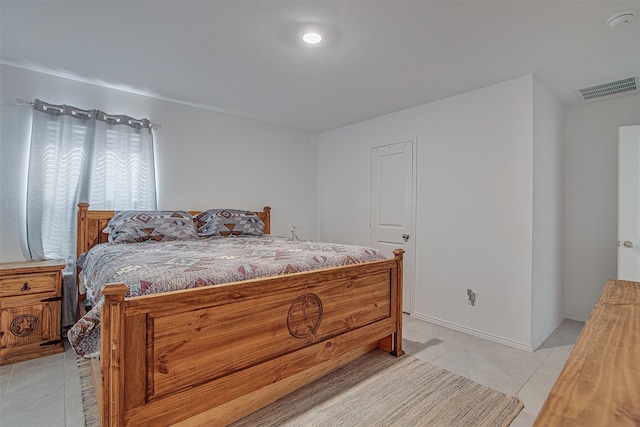 bedroom with light tile patterned floors