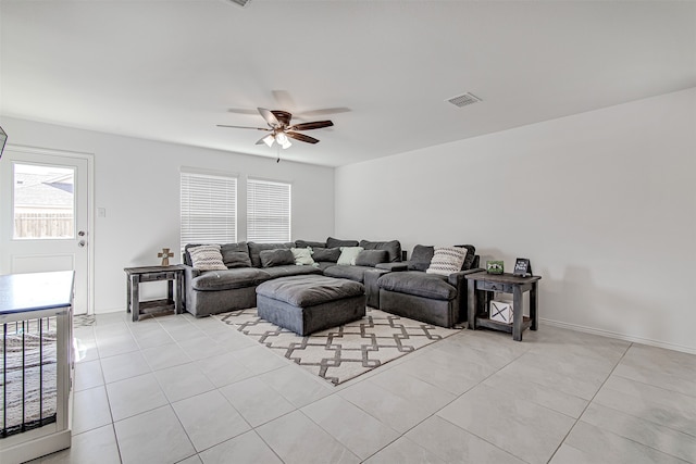 tiled living room with ceiling fan