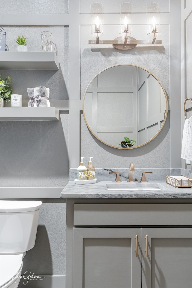 bathroom featuring vanity and toilet