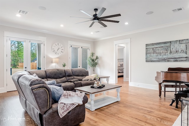 living room with french doors, ceiling fan, crown molding, and light wood-type flooring