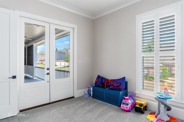 doorway to outside with crown molding, french doors, and carpet