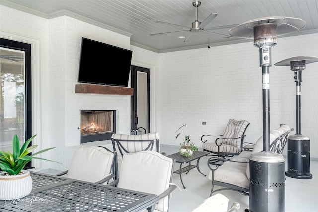 view of patio / terrace featuring ceiling fan and an outdoor fireplace