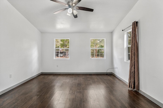 empty room featuring ceiling fan and dark hardwood / wood-style floors