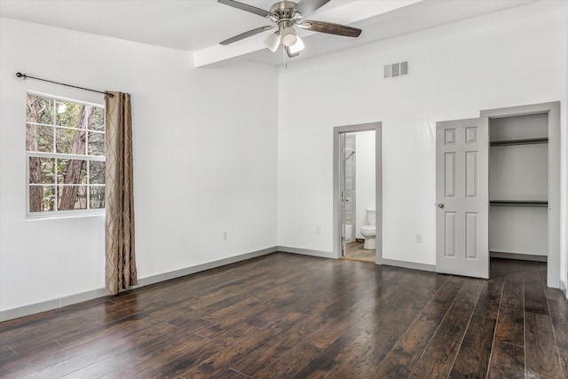 unfurnished bedroom featuring ceiling fan, dark hardwood / wood-style flooring, and connected bathroom