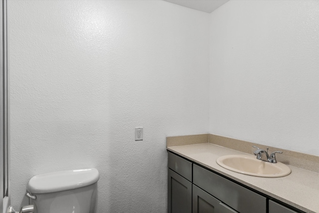 bathroom with toilet and vanity