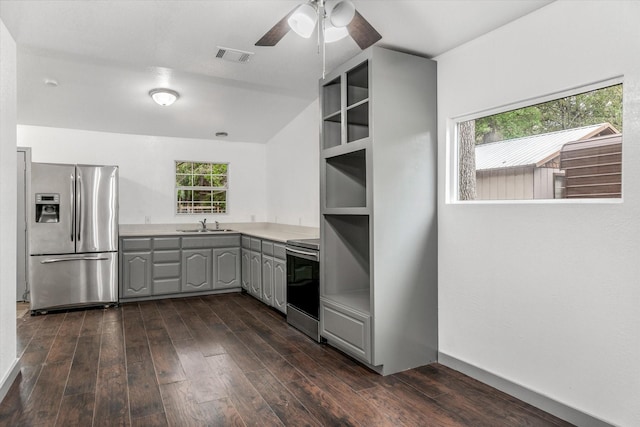 kitchen with appliances with stainless steel finishes, dark hardwood / wood-style flooring, sink, gray cabinets, and vaulted ceiling