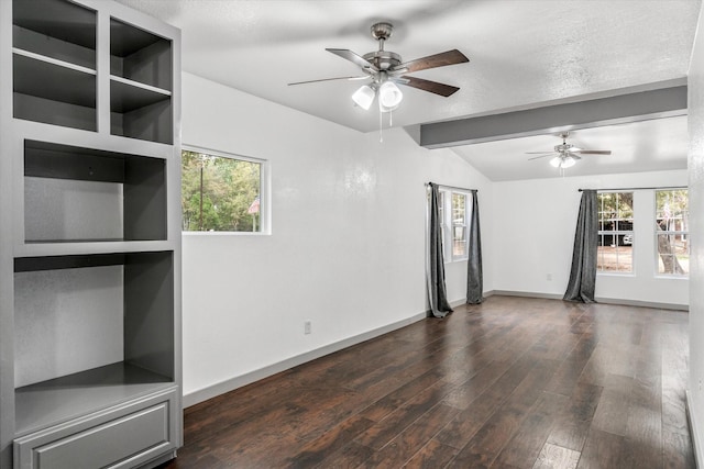 empty room featuring ceiling fan, built in shelves, and a wealth of natural light