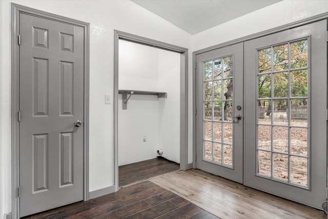 doorway to outside with dark hardwood / wood-style flooring, french doors, and vaulted ceiling