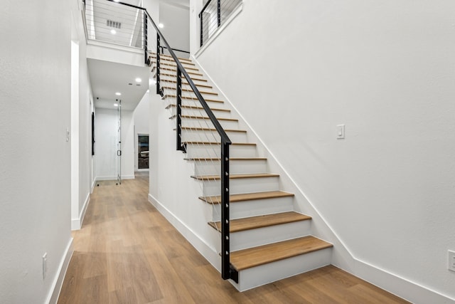 stairs featuring wood-type flooring