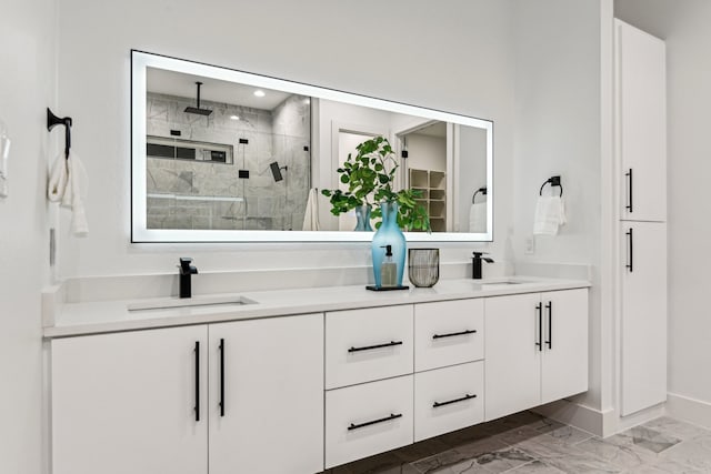 bathroom with vanity and tiled shower