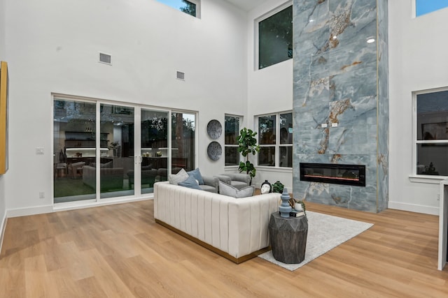 living room featuring light hardwood / wood-style floors and a high ceiling