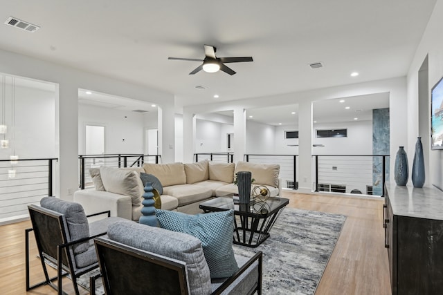 living room featuring ceiling fan and light wood-type flooring