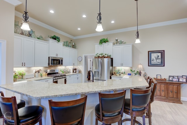 kitchen with decorative backsplash, appliances with stainless steel finishes, white cabinetry, light hardwood / wood-style flooring, and decorative light fixtures