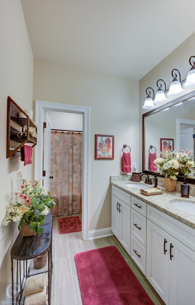 bathroom featuring vanity and hardwood / wood-style flooring