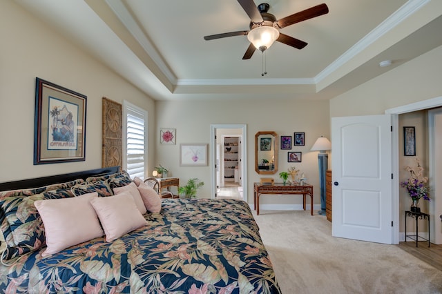 bedroom with ceiling fan, ornamental molding, a raised ceiling, and light carpet