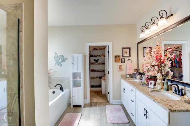 bathroom featuring vanity, hardwood / wood-style floors, and shower with separate bathtub