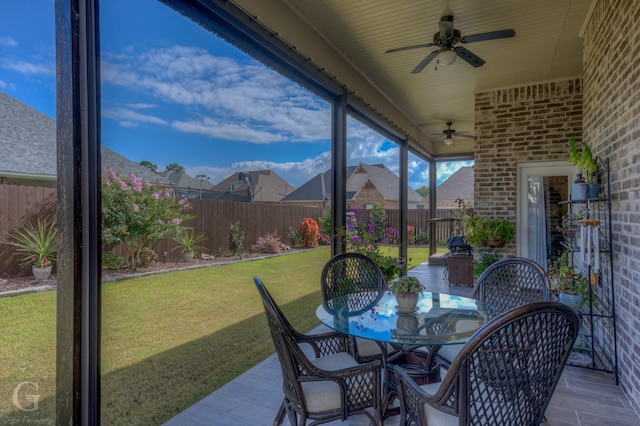 sunroom featuring ceiling fan