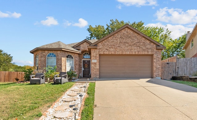 ranch-style home with a front yard and a garage