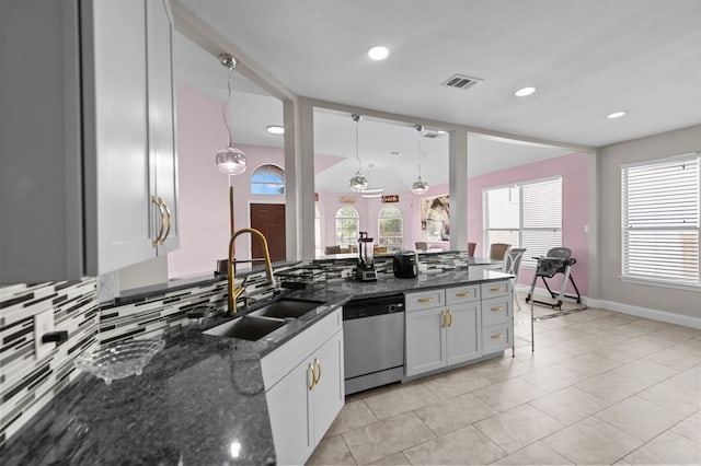 kitchen with white cabinetry, pendant lighting, dark stone counters, and stainless steel dishwasher