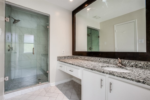 bathroom with vanity, tile patterned floors, and a shower with shower door