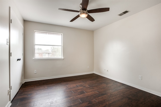 spare room with ceiling fan and dark wood-type flooring