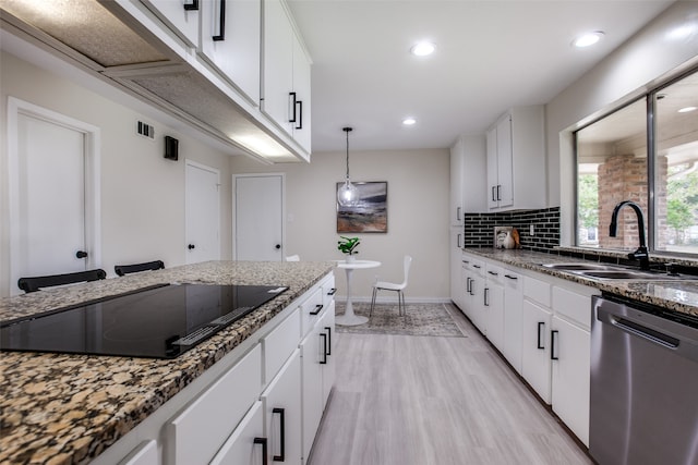 kitchen featuring dishwasher, sink, black electric stovetop, white cabinets, and light wood-type flooring