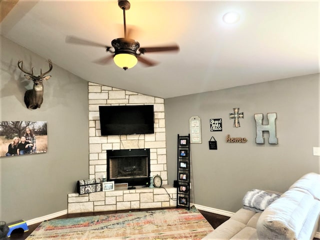 living room featuring ceiling fan, a fireplace, hardwood / wood-style floors, and lofted ceiling