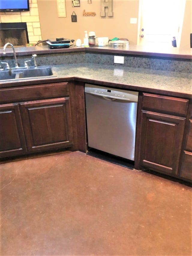 kitchen with stainless steel dishwasher, backsplash, dark brown cabinetry, and sink