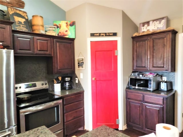 kitchen featuring backsplash, lofted ceiling, and stainless steel appliances